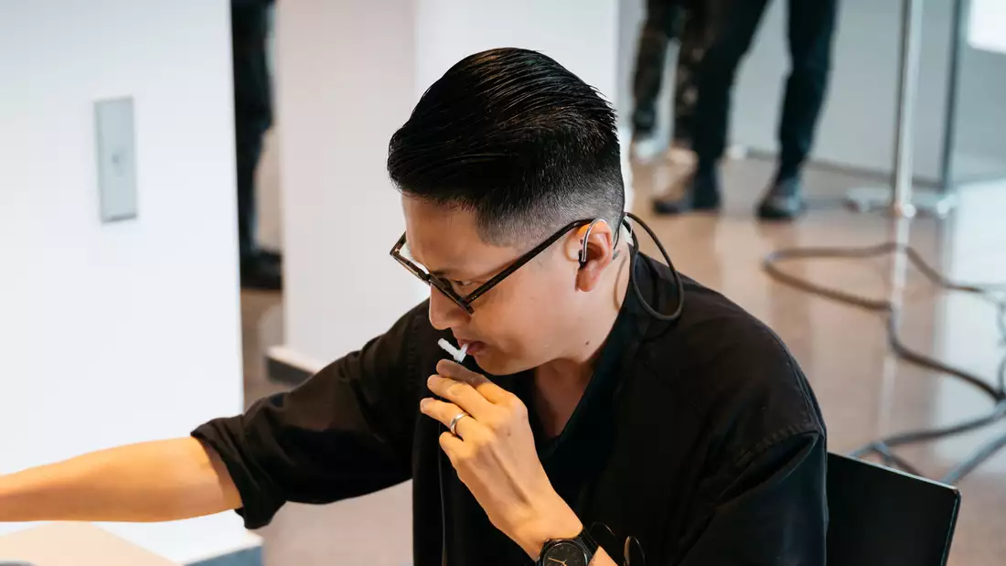 Samson Young in a black top looking to the left