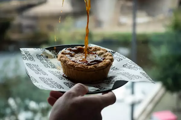 A pie with gravy being poured on it