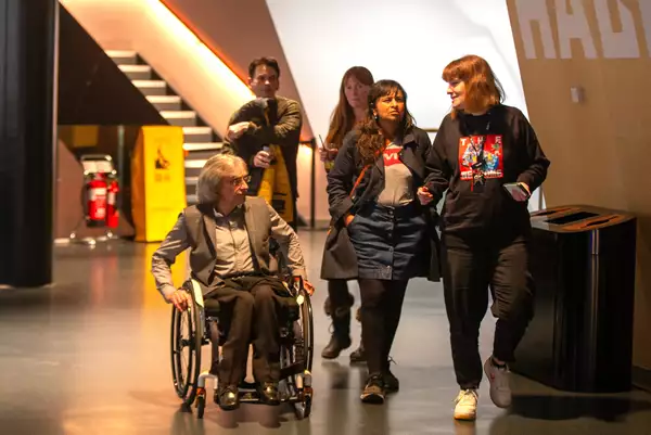 A group of people inside Aviva Studios.