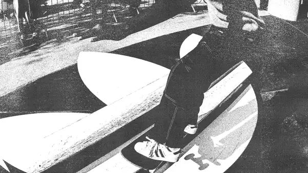 Black and white image of someone skateboarding on an Adidas skate ramp wearing Adidas trainers