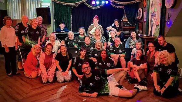 Brian Boru Ceili Dancers posing for a group photo in a decorated hall