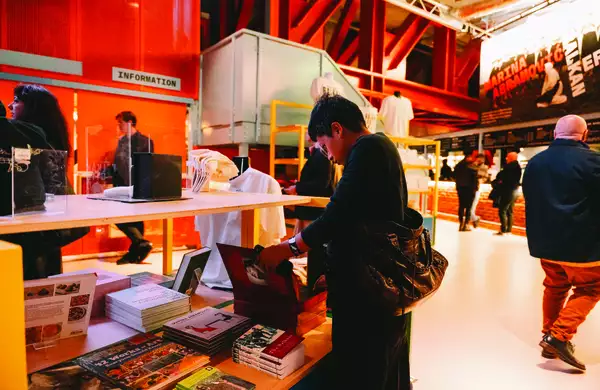 A person looking at books in the shop at Aviva Studios