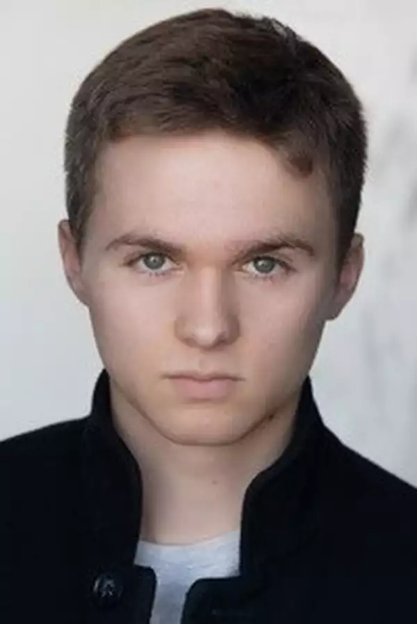 Gus Barry in a black overshirt with a white background