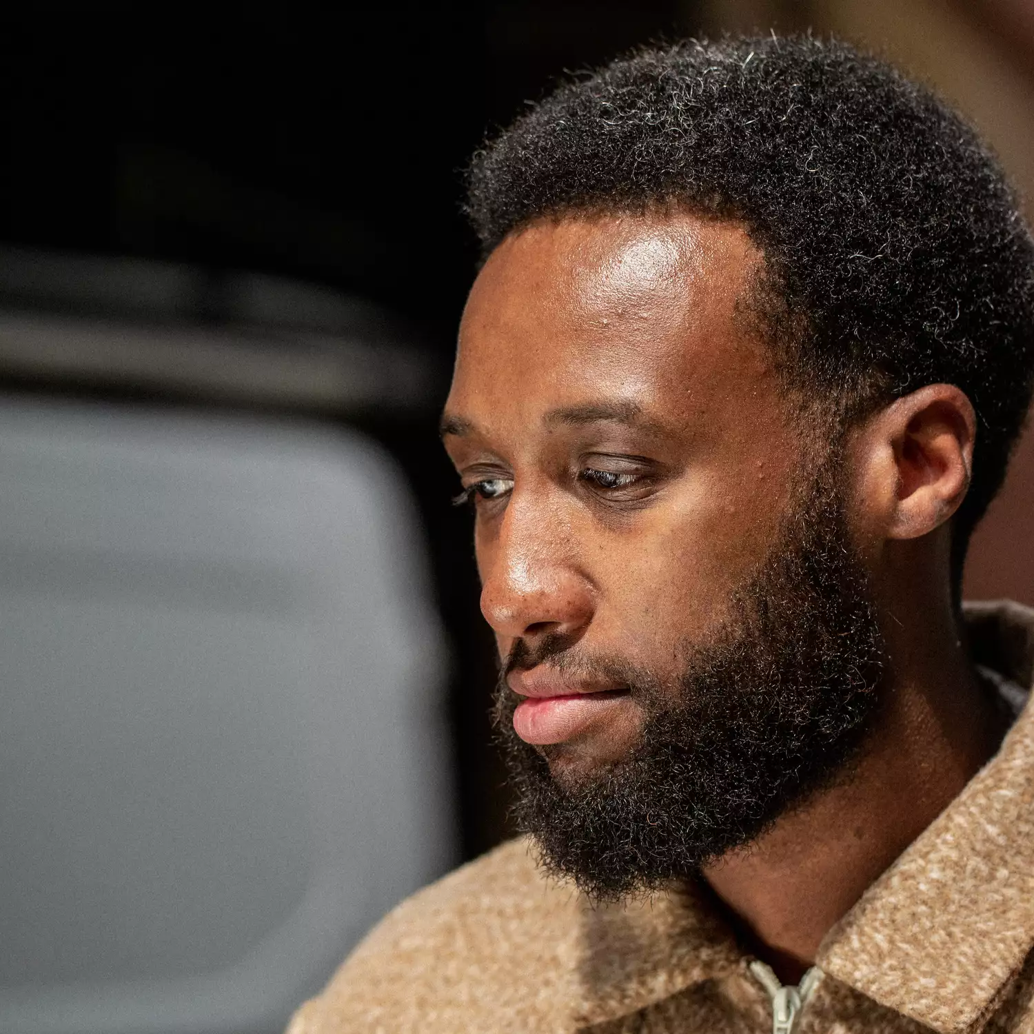 Headshot of Isaac Lynch looking down