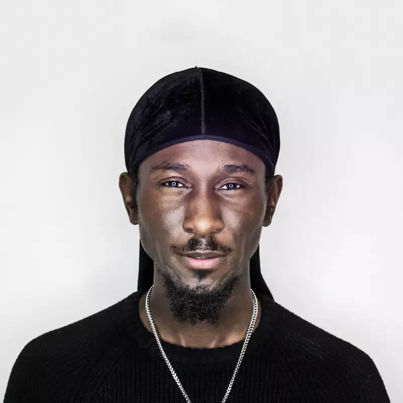Portrait of Cephas Williams wearing black on a white background