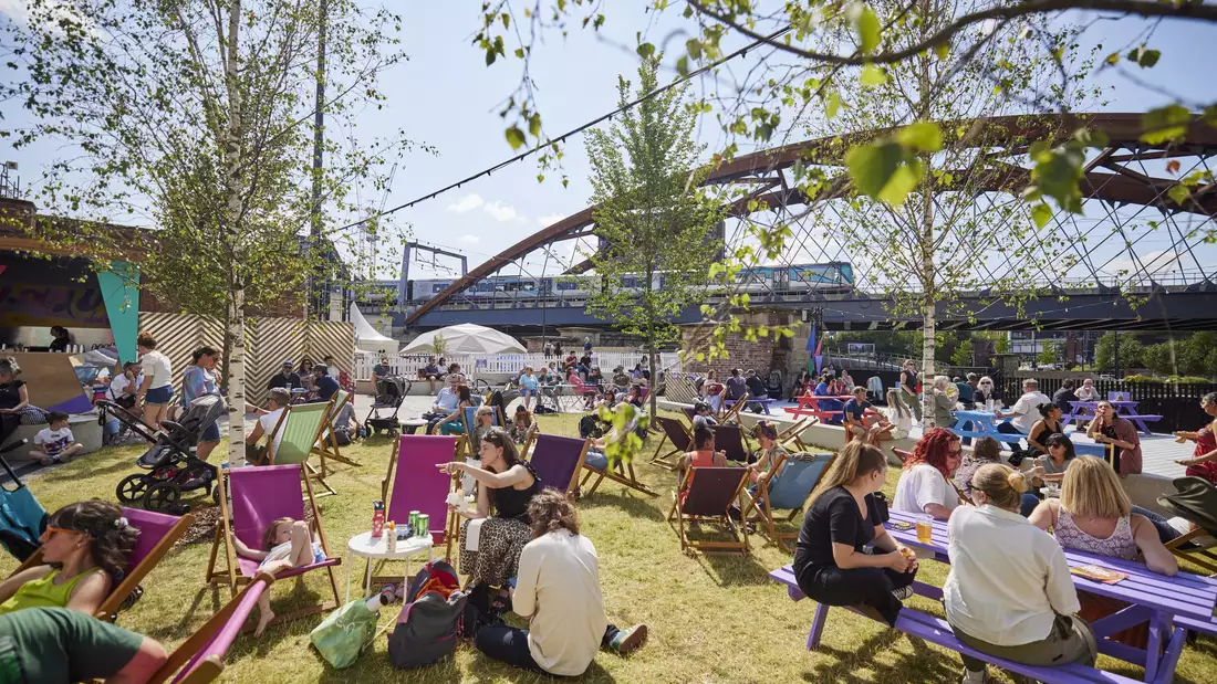 Photo of people chatting on deck chairs