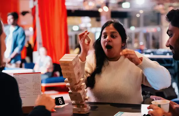 Someone playing Jenga – the tower is mid-falling