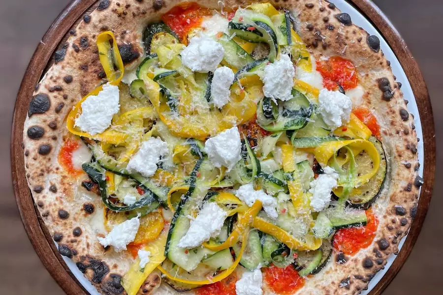 Pizza from Honest Crust with vegetables and cheese on