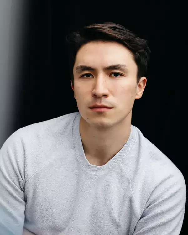 Headshot of Brandon Grace wearing a light grey jumper