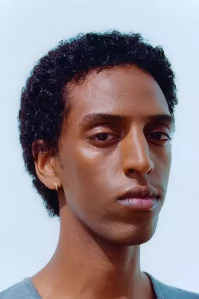 Headshot of Natnael Dawit on a pale blue background