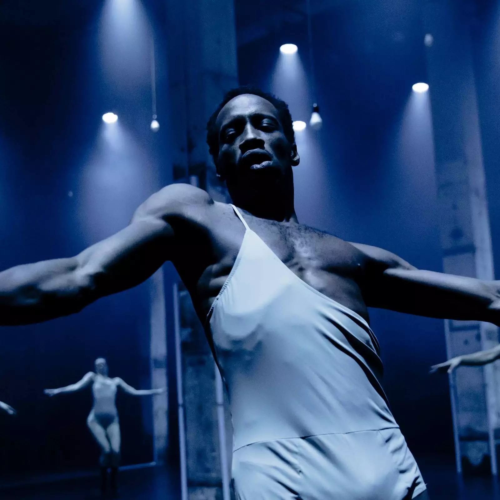 A dancer in a nightclub wearing a silver costume