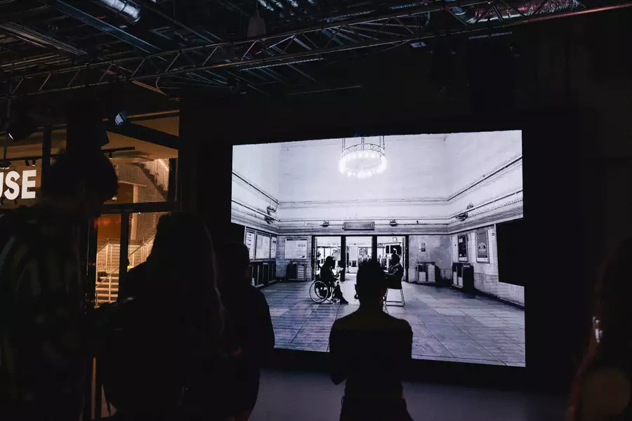 People gathered in the Social watching a film on the big screen