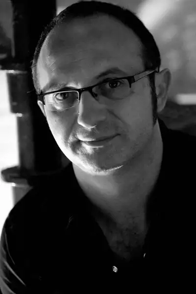 Headshot of Dan Potra wearing a black shirt