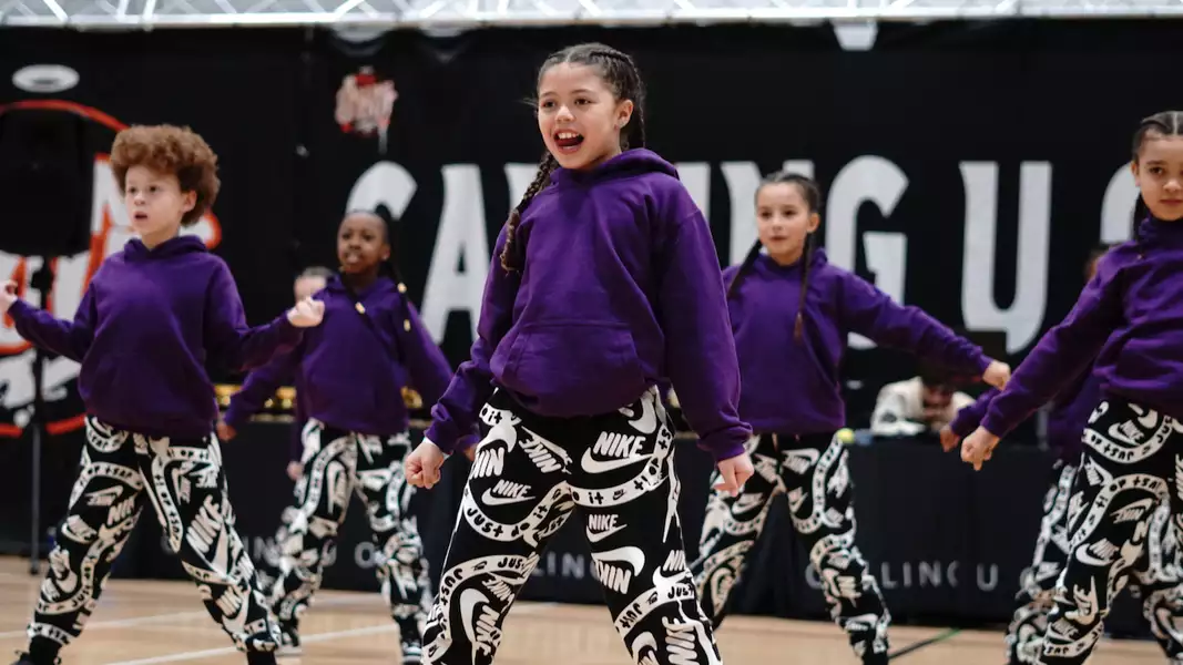 children in purple sweatshirts dancing