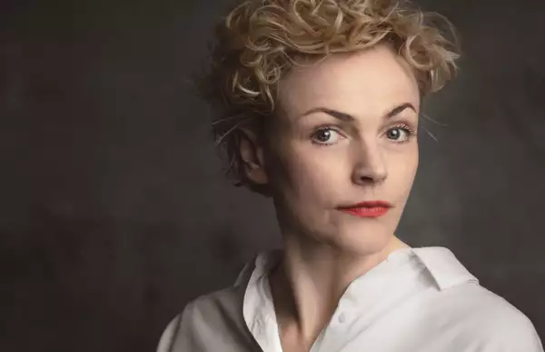 A headshot of the actor Maxine Peake wearing a white shirt