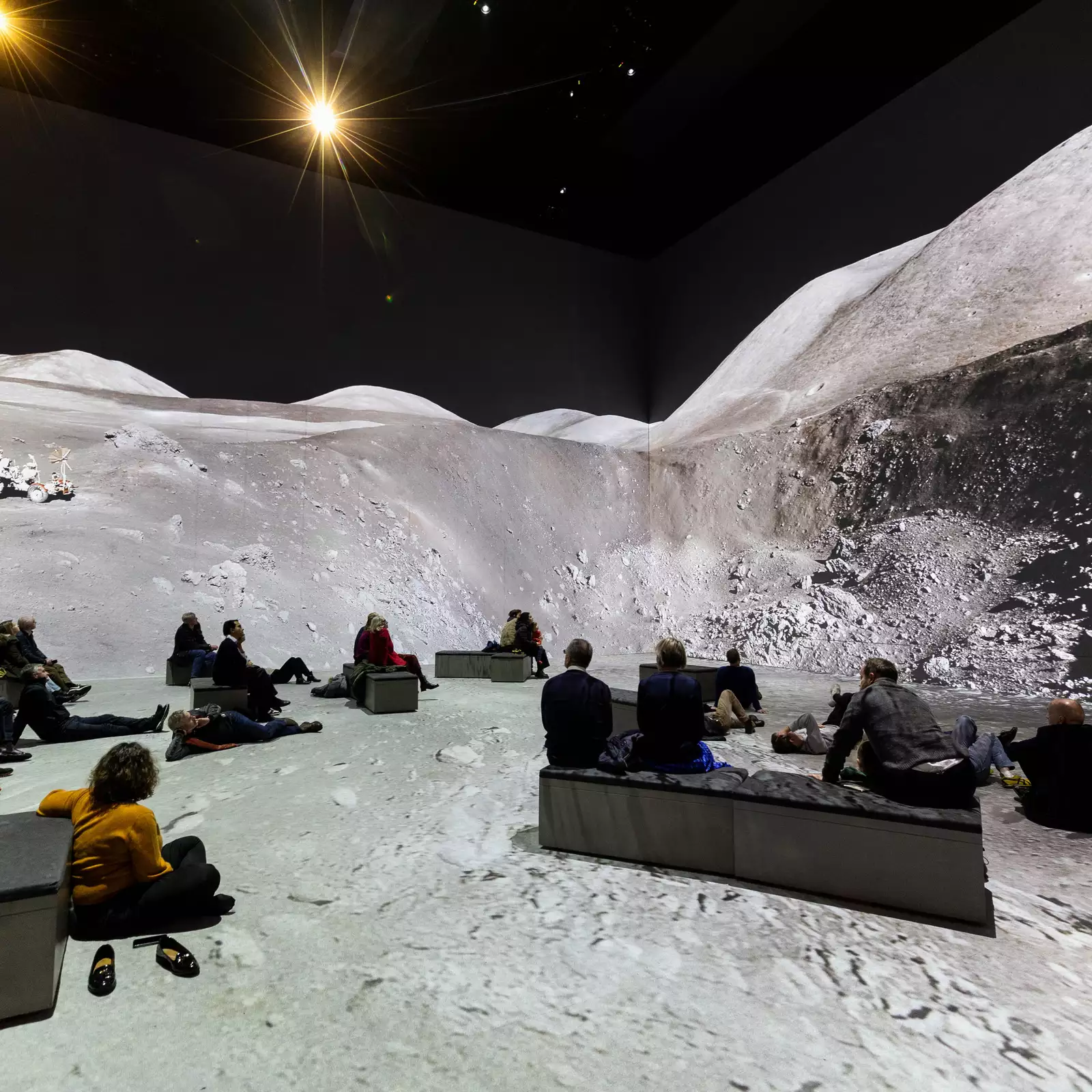 People watching The Moonwalkers, showing a scene on the moon