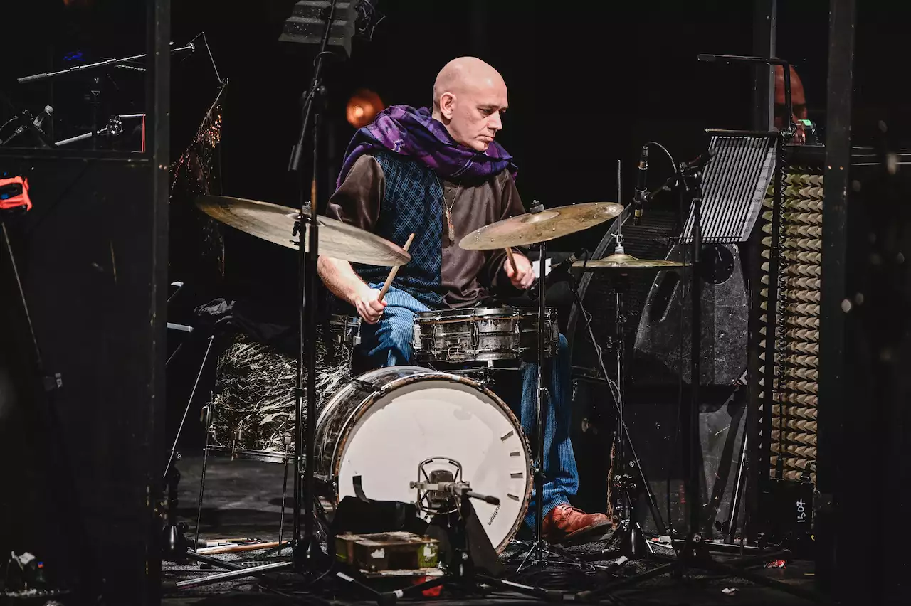 An orchestra member playing drums