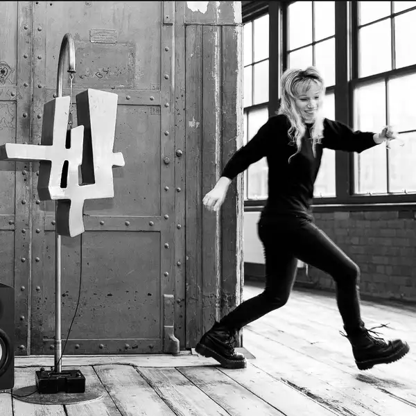 Black and white photo of Vicky Clarke in a studio