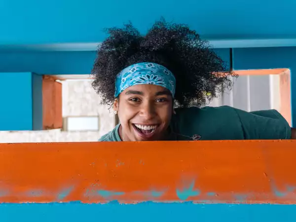 FREEQUENCY3 - one of the Factory Sounds 2023 artists - smiles at the camera wearing a blue bandana