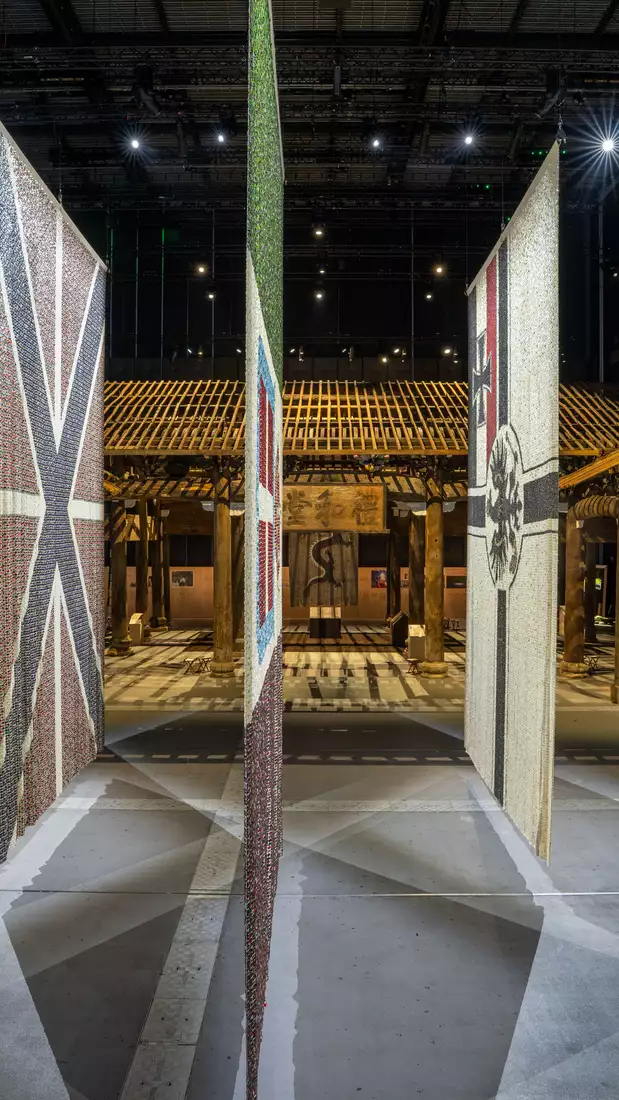 Five flags from the Eight-Nation Alliance Flags on display in the exhibition, with the Wang Family Ancestral Hall visible behind