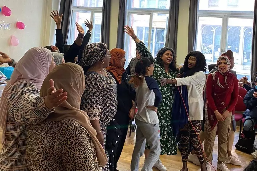 Members of WAST Choir singing and waving their hands in the air