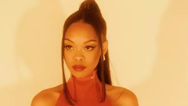 Kahreign with their hair tied in a ponytail on a yellow background