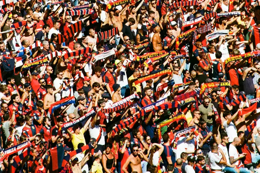 A film photograph of a crowd in a football stadium