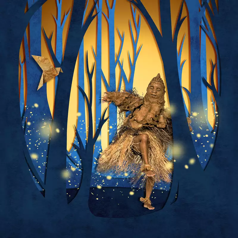 A dancer wearing a light brown costume and puppet mask, moves in a glowing forest of tall blue and golden trees, surrounded by floating firefly-like lights.