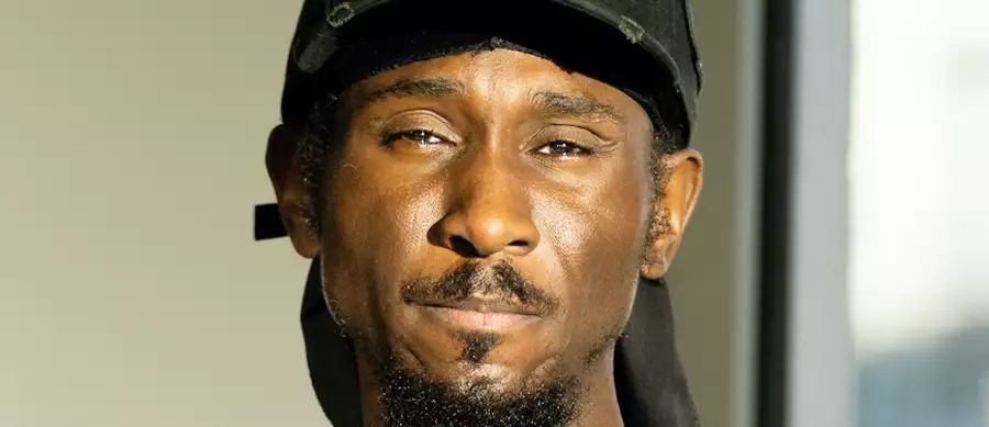 Headshot of Cephas Williams wearing a black cap that says 'icon'