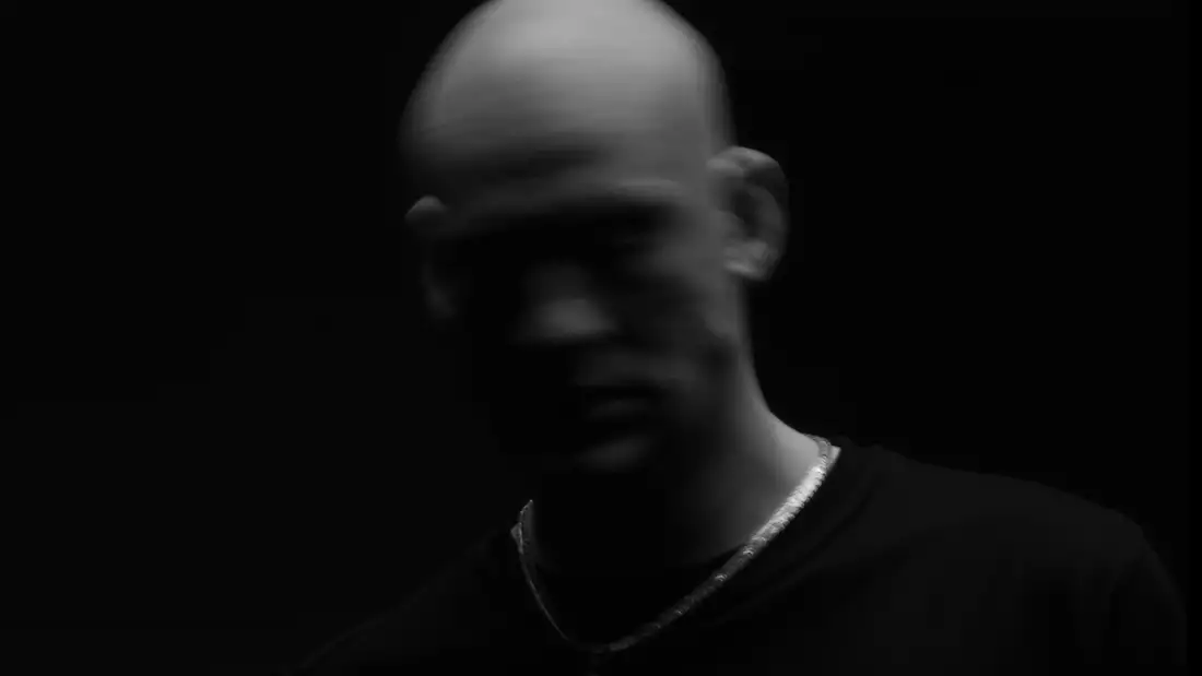 A black and white portrait of Blackhaine