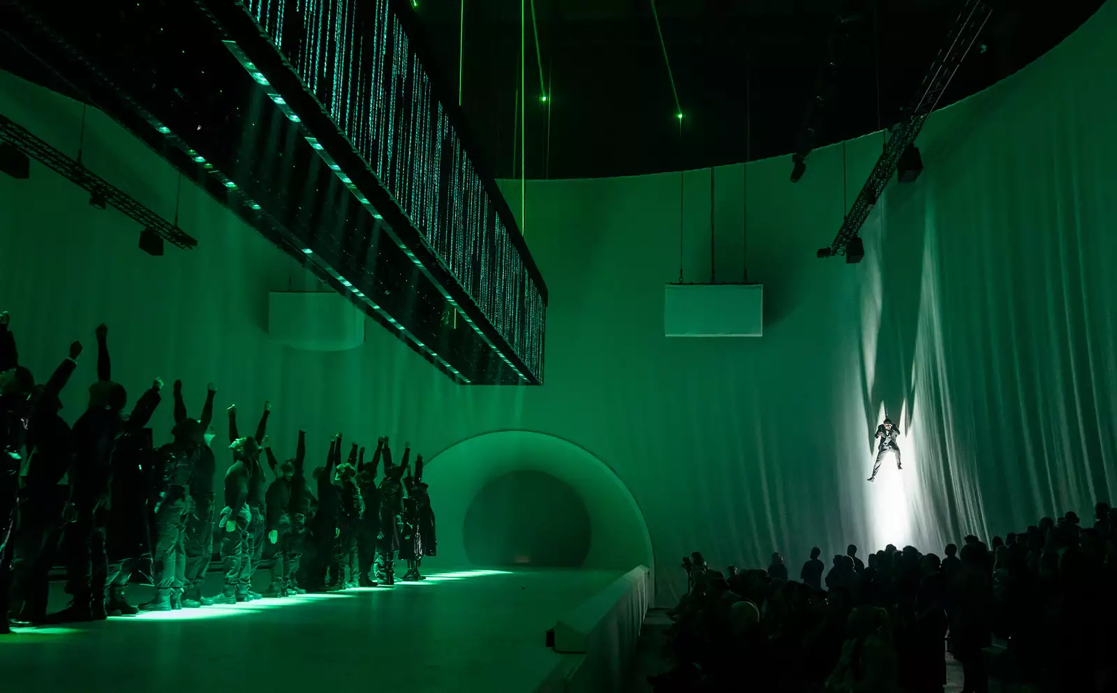 Dancer suspended in the air in Free Your Mind with green lighting