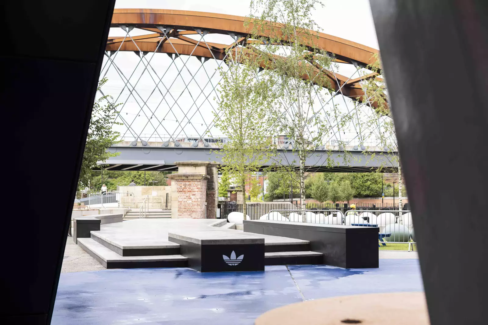 An adidas branded skate ramp in the Undercroft, with a view of the bridge over the River Irwell