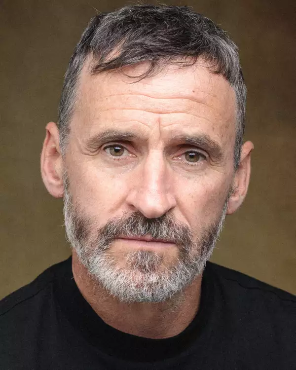 Headshot of Tom Peters wearing a black top
