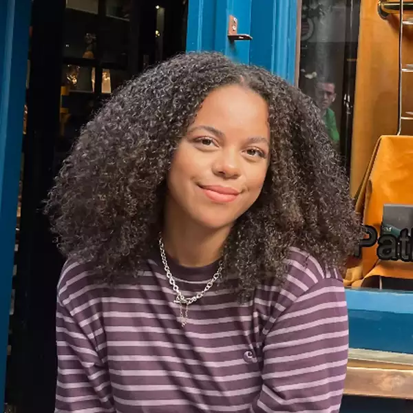Square headshot of Rachel Morgan smiling and wearing a purple striped top