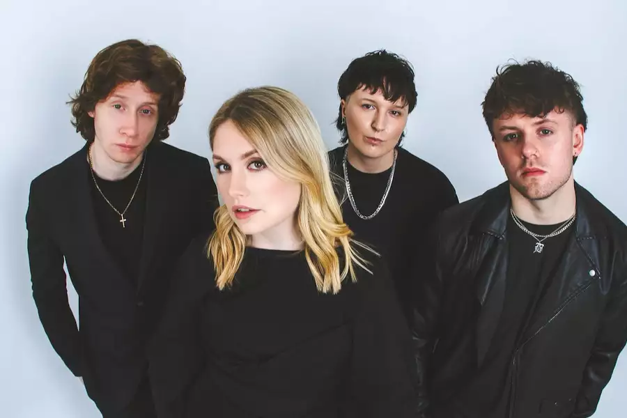 Four members of Pave wearing black on a white background