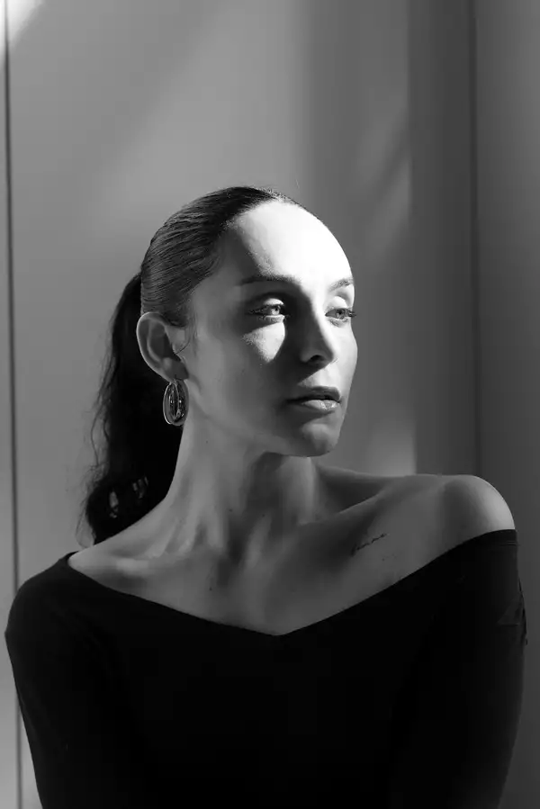 Black and white headshot of Naia Bautista looking to the side