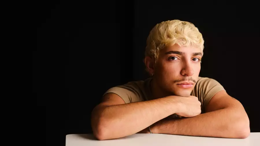 Headshot of Adam Ali on a black background
