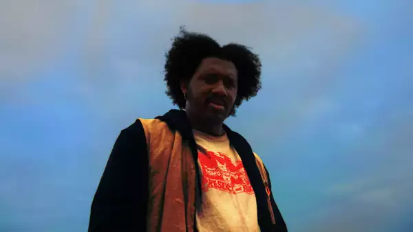 Photo of Hang Linton taken from below. The blue sky is behind them.