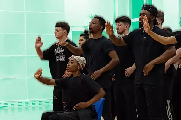 Photo of a group of people dancing in front of a bright green background