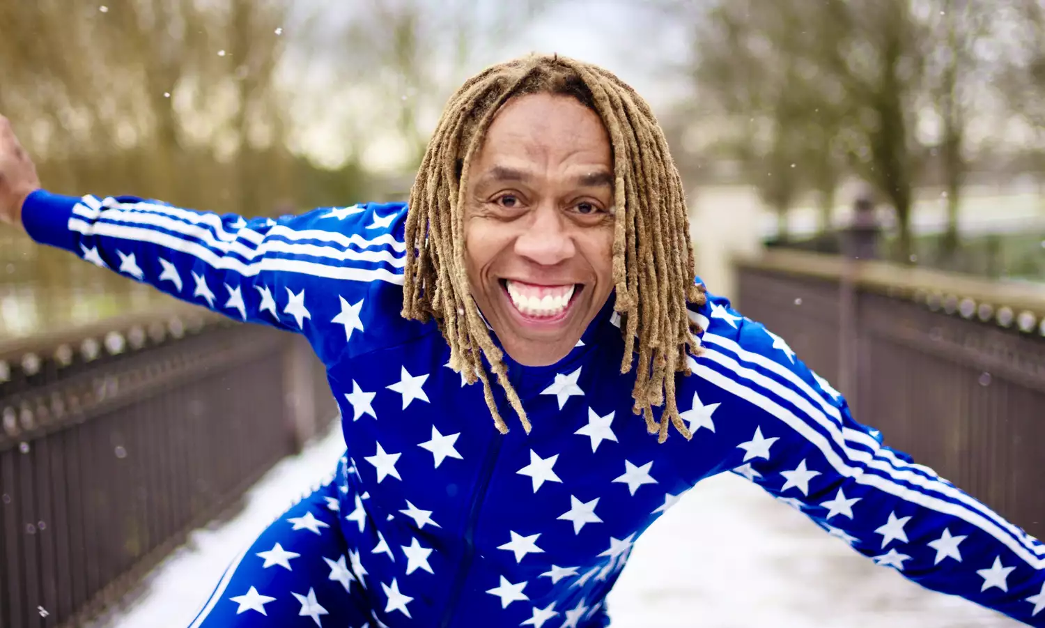 Rikki Beadle Blair wears a blue tracksuit with white stars