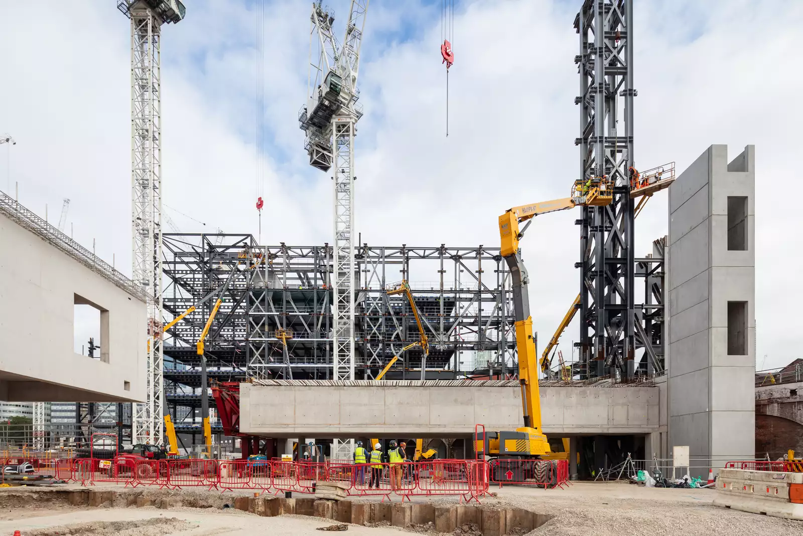 Construction site with a yellow crane in the foreground