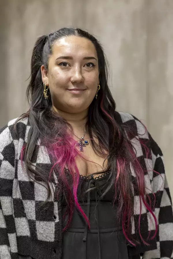 Portrait photograph of Emma Naughton wearing a black and white chequered jacket