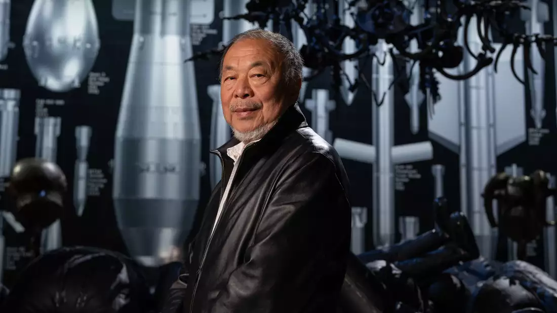 Ai Weiwei stood in front of History of Bombs – a giant artwork featuring 50 life-size bombs