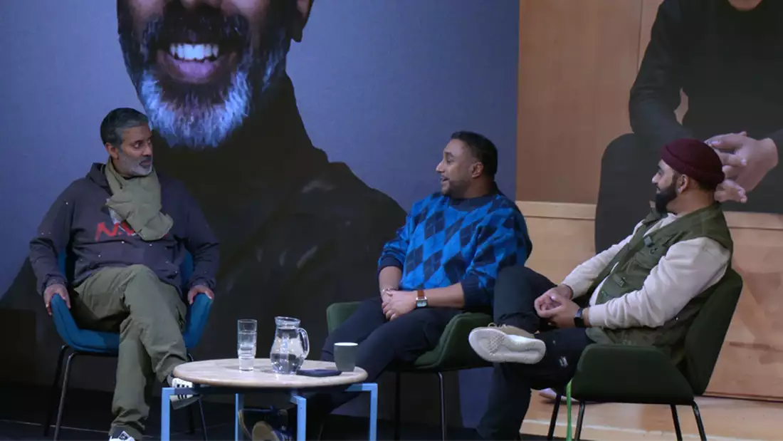 Nihal Arthanayake and two members of Tribe Arts sat on chairs during a panel discussion