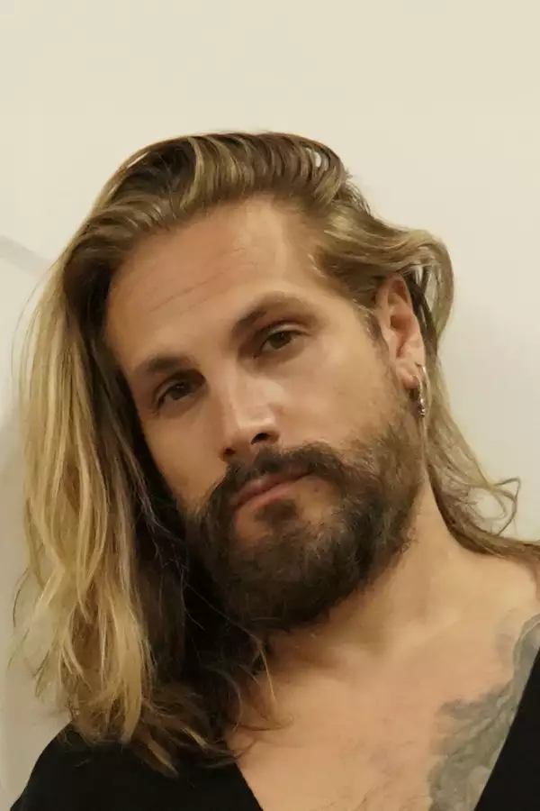 Headshot of Marco Perego wearing a black top