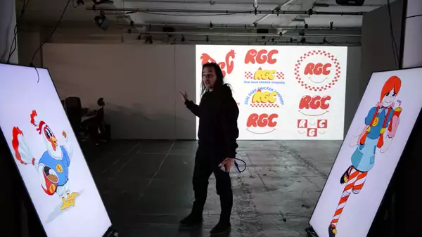 Robin McNicholas stood in front of three large screens showcasing the branding behind his upcoming show Sweet Dreams