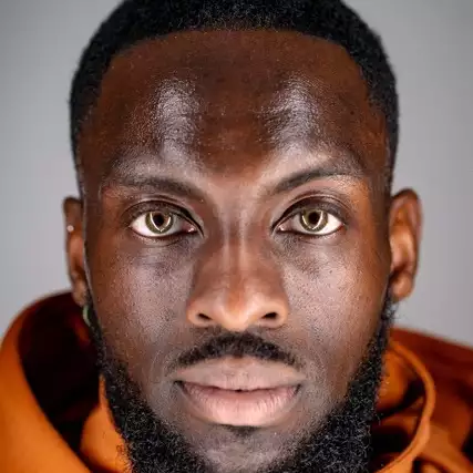 Headshot of Chad Taylor wearing an orange top