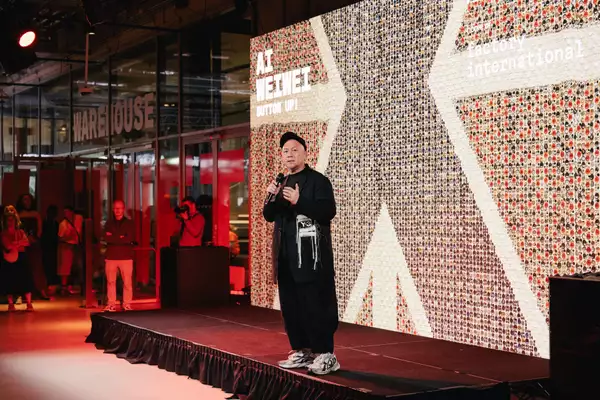 Kee Hong Low stood on the stage in the Social speaking into the microphone