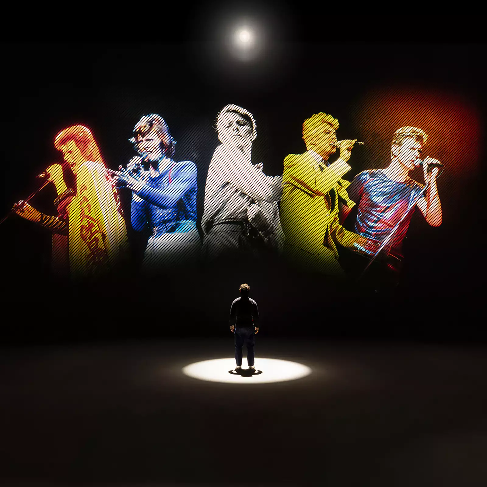 A person looking at five versions of David Bowie singing on a large screen