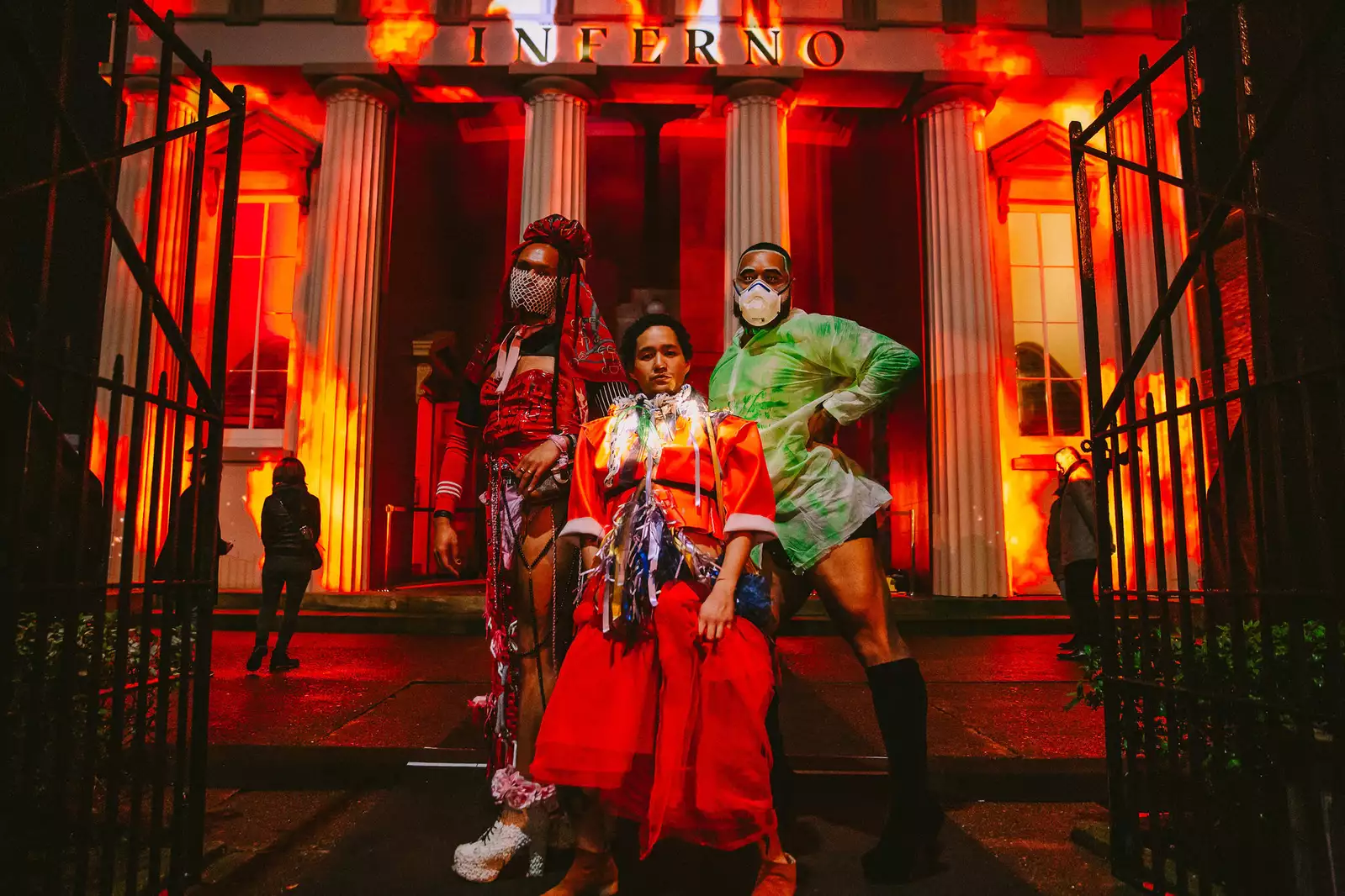 FAFSWAG artists in front of a museum lit up in red with the title inferno at the top